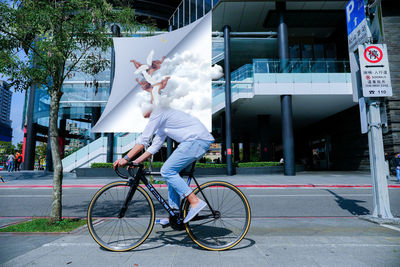 Man riding bicycle on road