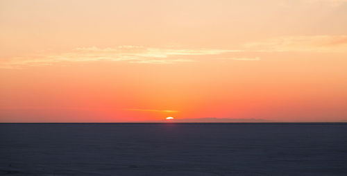 Scenic view of sea against romantic sky at sunset
