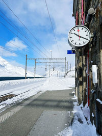 Snow covered road against sky