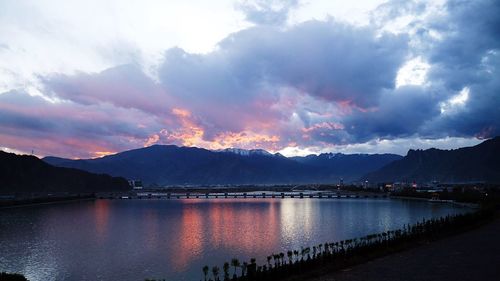 Scenic view of lake in front of mountains against sky