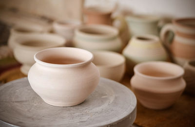 Many clay pot is on the table in pottery. copy spase