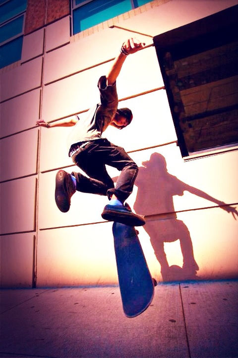 full length, leisure activity, lifestyles, sport, men, jumping, skill, low angle view, balance, holding, mid-air, outdoors, vitality, fun, sky, built structure, risk, rope