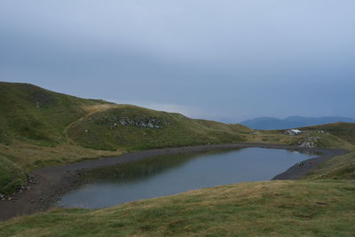 Scenic view of lake and mountains against sky