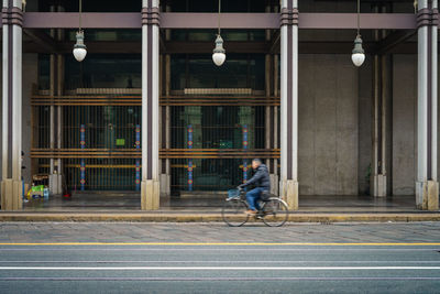 Man riding bicycle on road