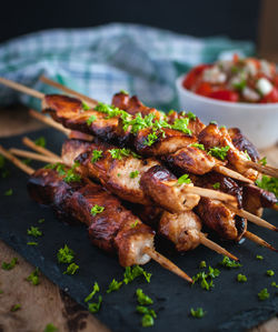 Close-up of homemade honey and beer bbq chicken skewers with fresh parsley