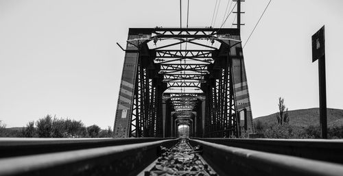 Surface level of railroad bridge against clear sky