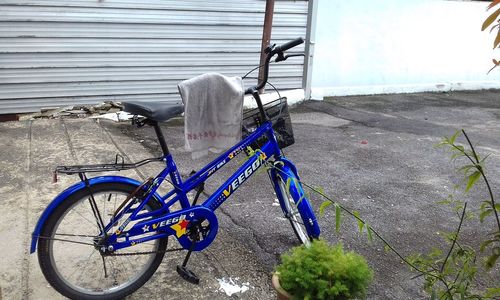 Bicycle parked against brick wall