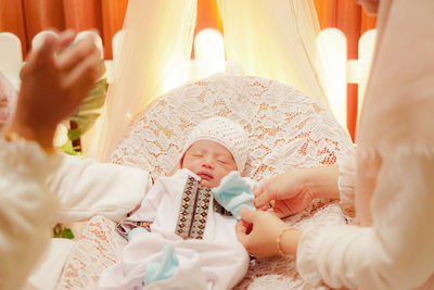 Midsection of baby girl lying on bed