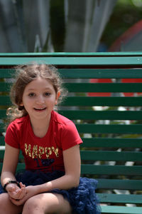 Portrait of smiling girl sitting outdoors