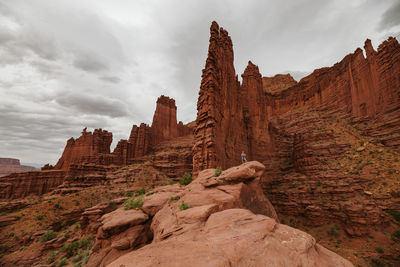 Hiking at fisher towers under cloudy skies near moab utah