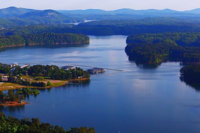 Scenic view of lake and mountains against sky