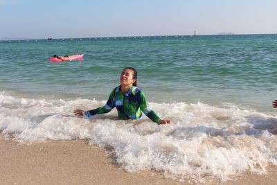 Full length of boy on beach against sky