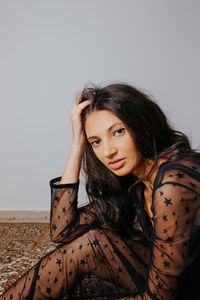 Portrait of a young woman sitting outdoors