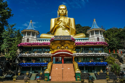 Low angle view of statue against temple building