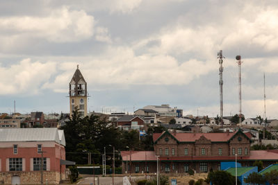 Buildings in town against sky