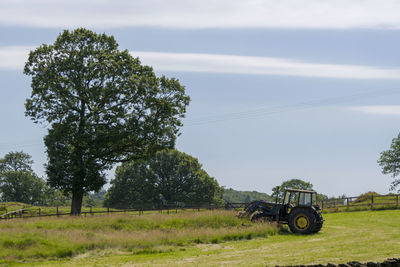 Tractor on field against sky