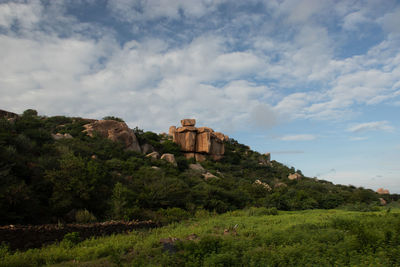 Built structure on landscape against sky