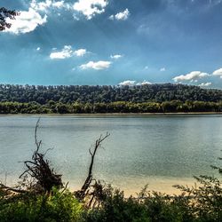 Scenic view of lake against cloudy sky