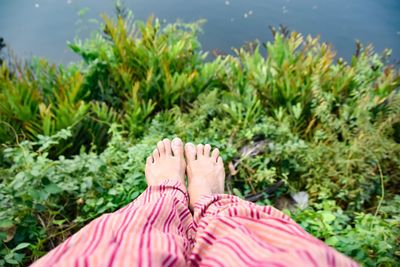 Low section of woman relaxing on land