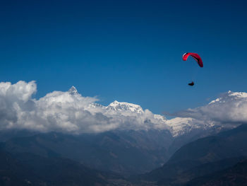 Paragliding over himalayas in clouds, pokhara nepal