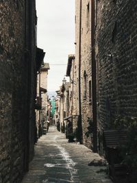 Narrow alley amidst buildings against sky