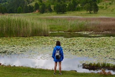 Rear view of woman standing on shore