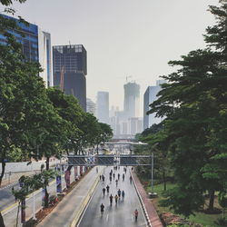 View of city street and buildings against sky