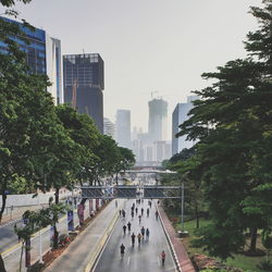 View of city street and buildings against sky