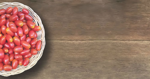 High angle view of strawberries in basket on table