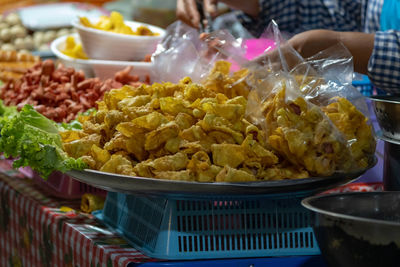 Midsection of person having food in market