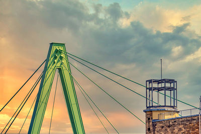 Low angle view of bridge against sky at sunset