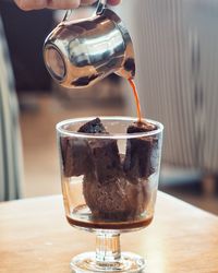 Chocolate syrup in cake on table