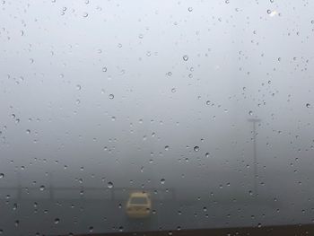 Full frame shot of wet glass window during rainy season