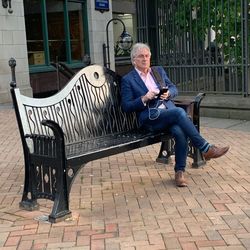 Man sitting on bench in park