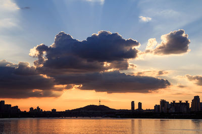 Scenic view of silhouette buildings against sky during sunset