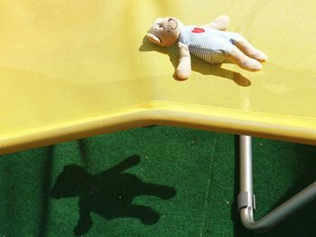 High angle view of teddy bear on deck chair