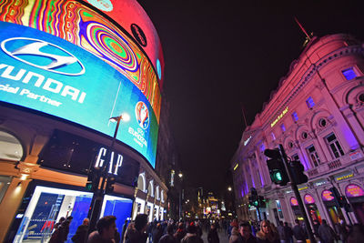 People in illuminated city at night