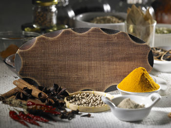 Various spices with cutting board on table