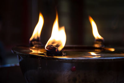 Fire from candles lantern in temple, close up of candle flame