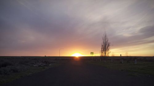 Scenic view of field against sky during sunset