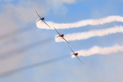 Low angle view of helicopter flying against sky