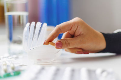 Cropped hand of scientist holding dentures