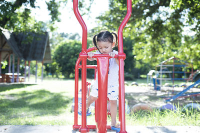 Rear view of boy playing in playground