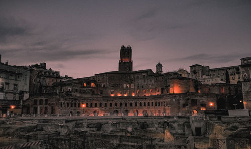 Buildings in city at sunset