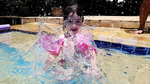 High angle view of girl swimming in pool
