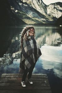 Portrait of woman standing by lake