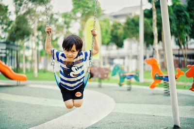 Cute girl with arms raised in background