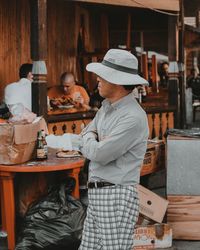 Rear view of man and woman standing at table