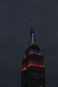 Low angle view of illuminated building against sky at night