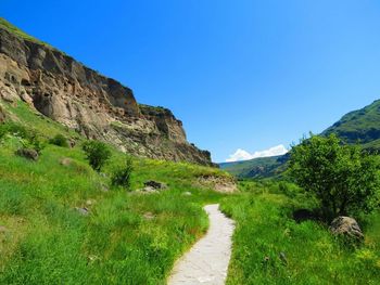 Scenic view of mountains against clear blue sky